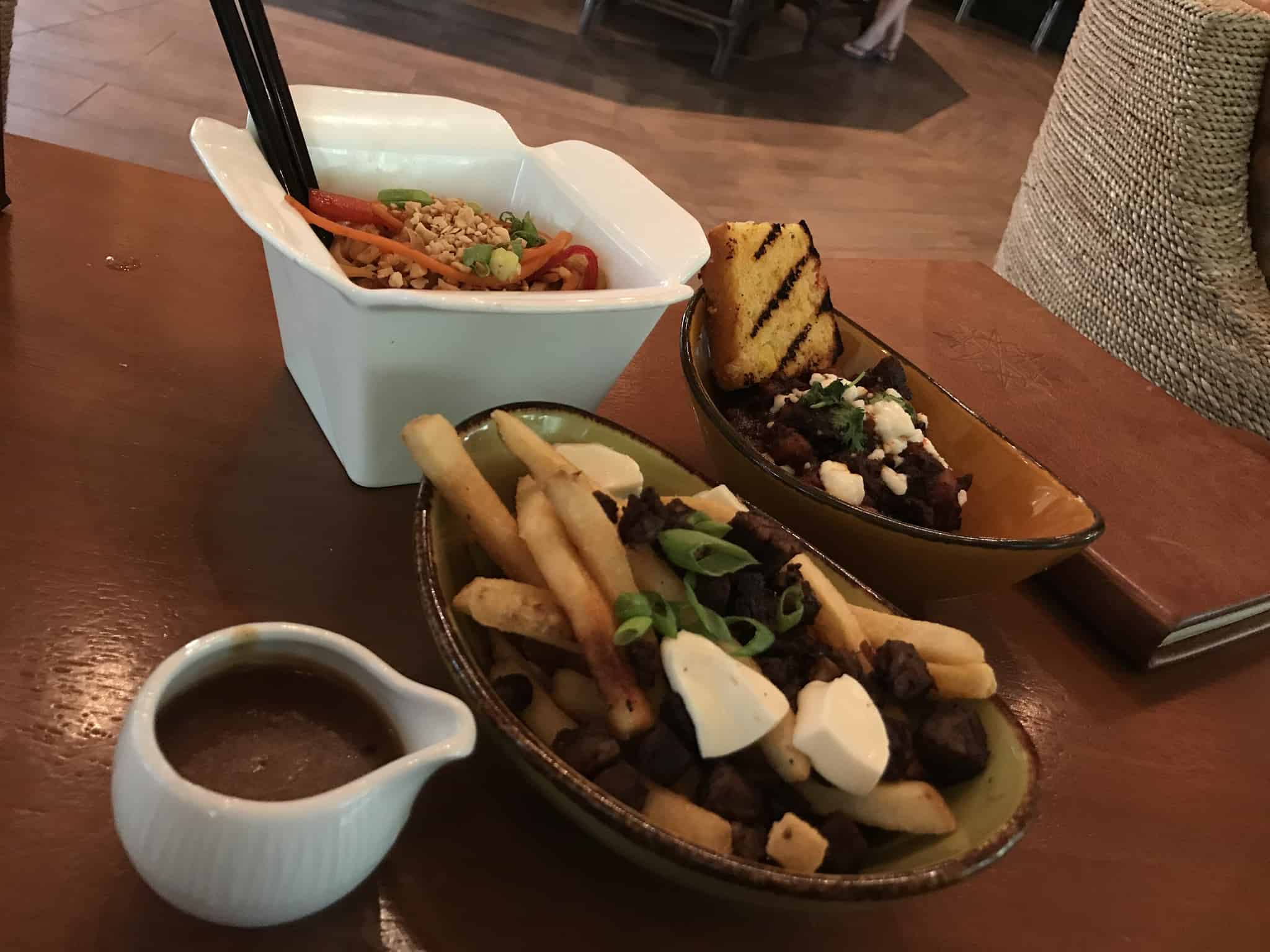 REVIEW: Nomad Lounge at Animal Kingdom Adds Poutine, Pad Thai, and Beef Posole to the Menu
