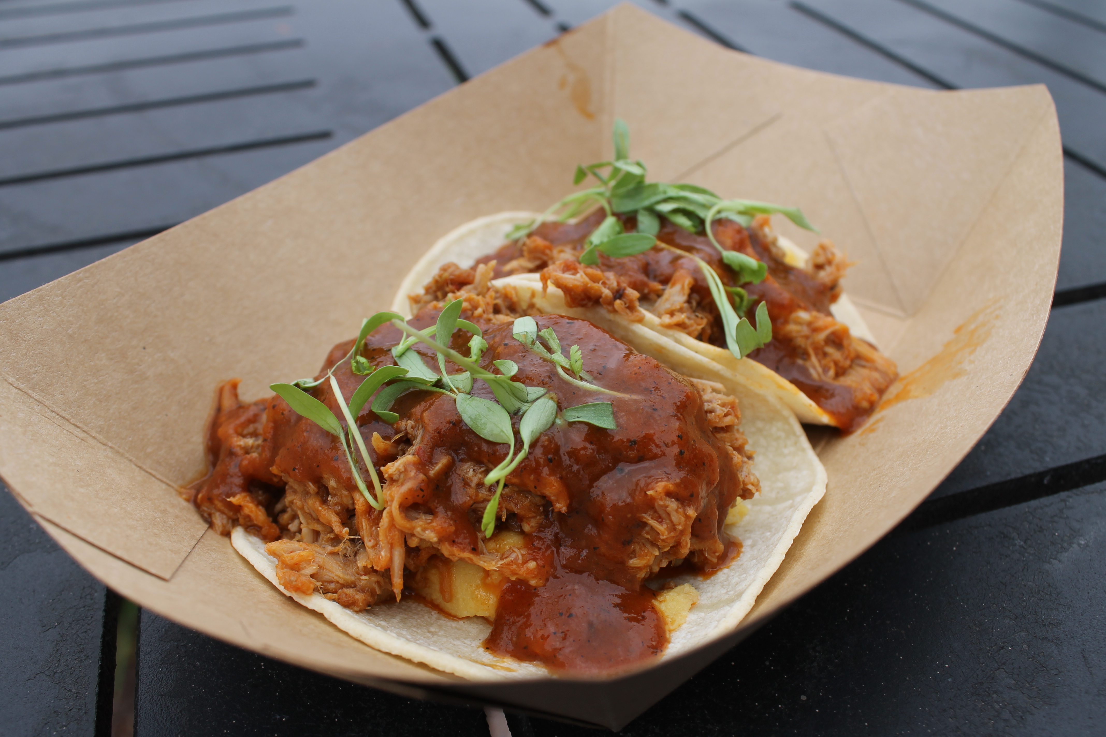 Tacos de Puerco: Two Corn Tortillas with Slow-roasted Pork Shoulder marinated in Ancho Paste, served with Sweet Plantain Pur&eacute;e and garnished with Pea Tendrils $9.95