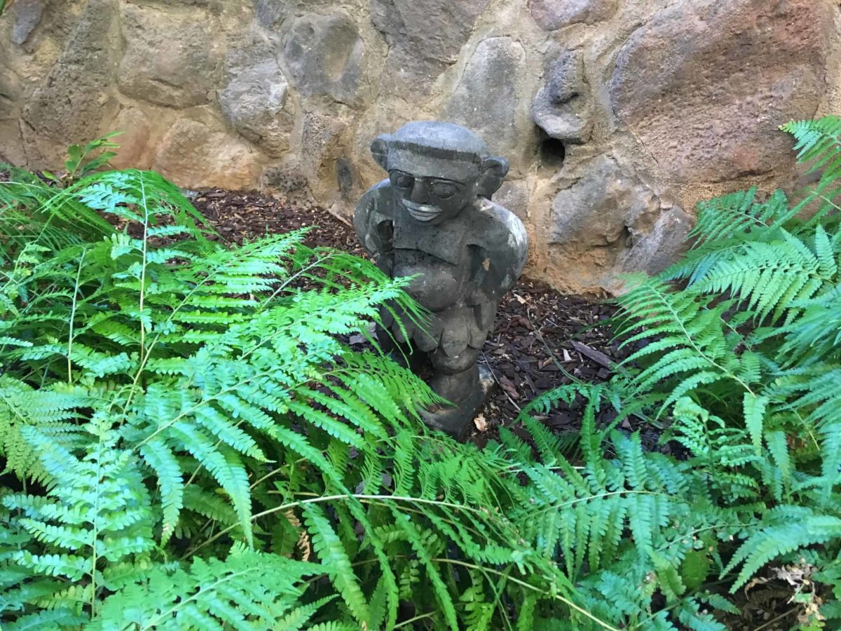 This Menehune is found near a wall along a garden path at the Aulani