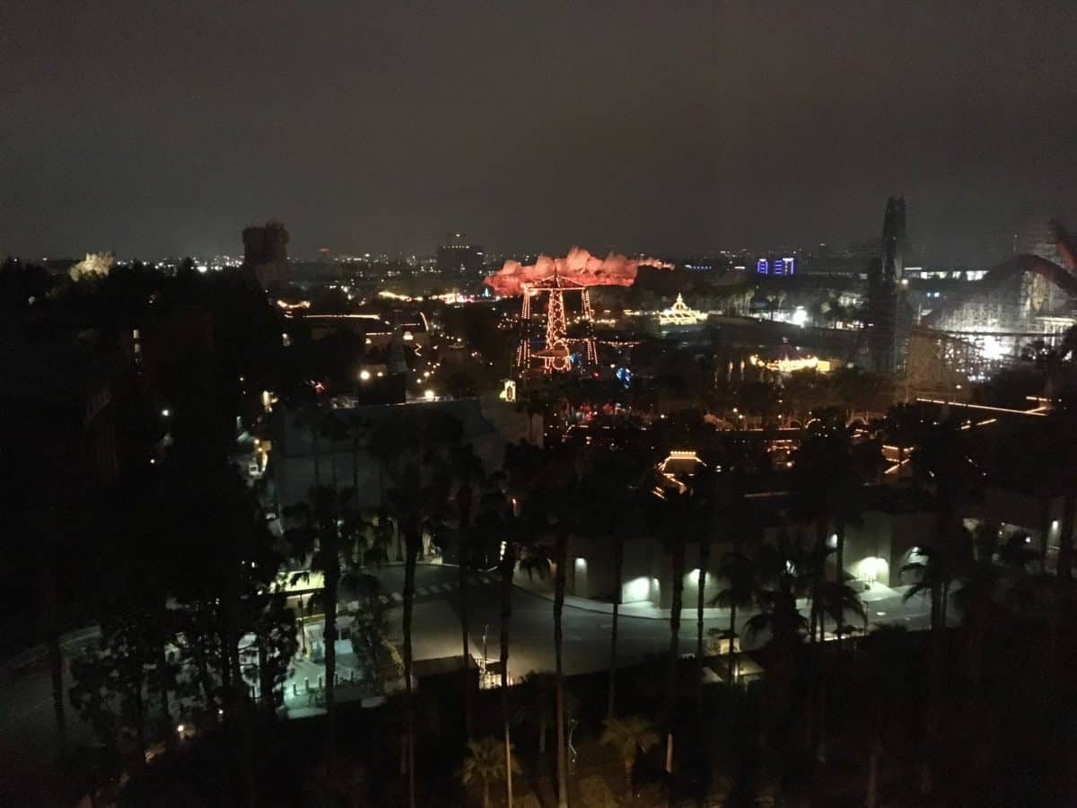 A nighttime look out the window of a Premium View room at Disney's Paradise Pier Hotel at the Disneyland Resort