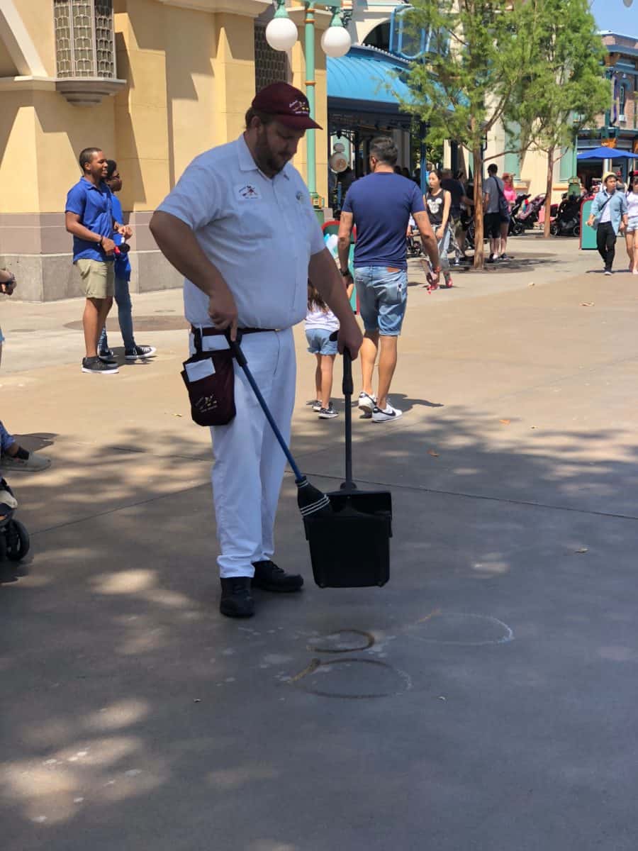 A janitor in Disney California Adventure painting PIXAR characters on the cement with water, as seen on May 10, 2018