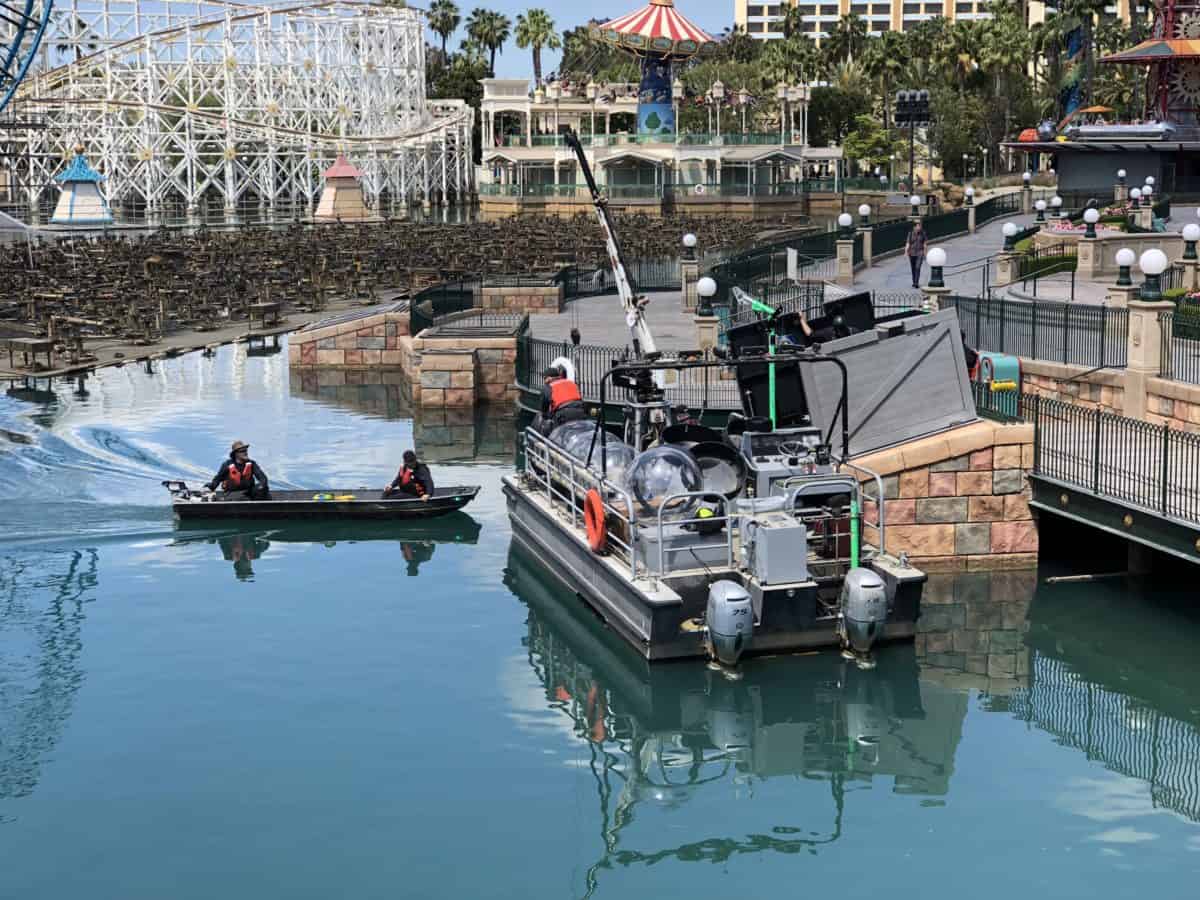 Construction workers carry equipment over to PIXAR Pier (photo taken May 16, 2018)
