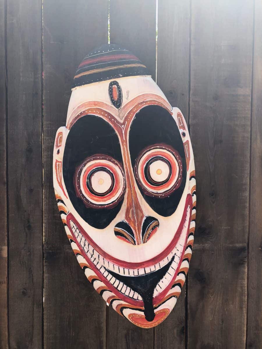 A tiki mask decorating the outside of the construction wall for the future Tropical Hideaway in Adventureland in Disneyland