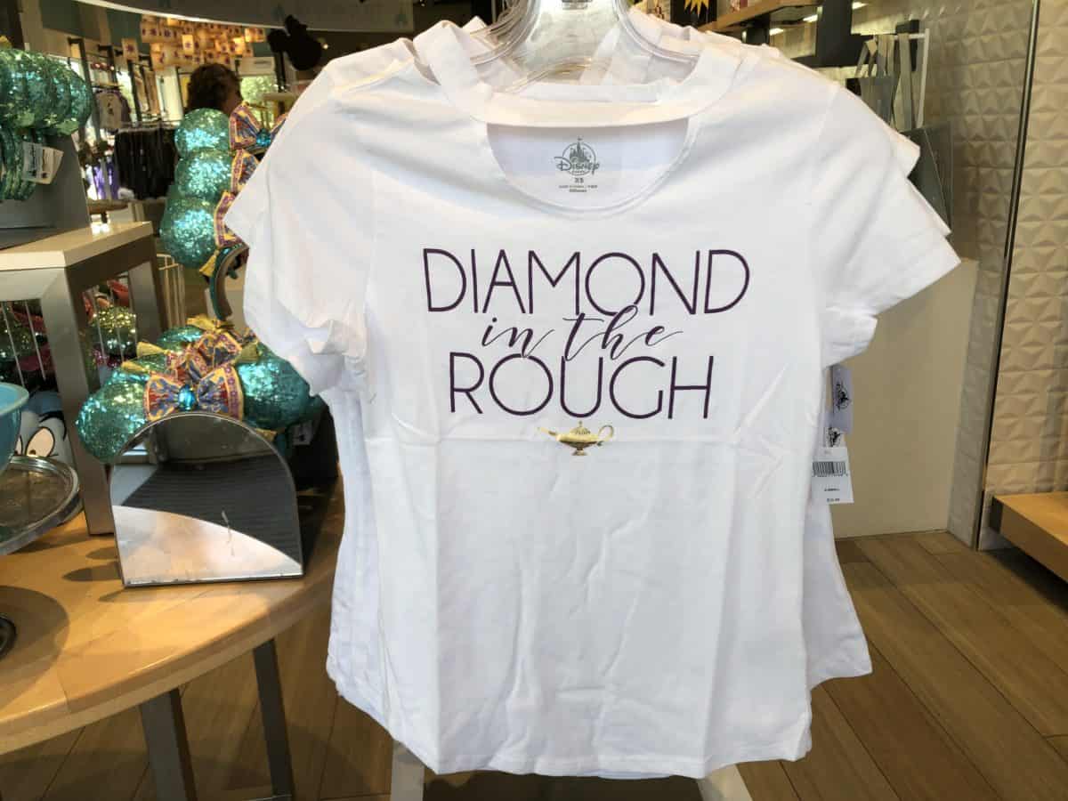 white shirt with cut outs, Diamond in the Rough text with the Genie lamp.
