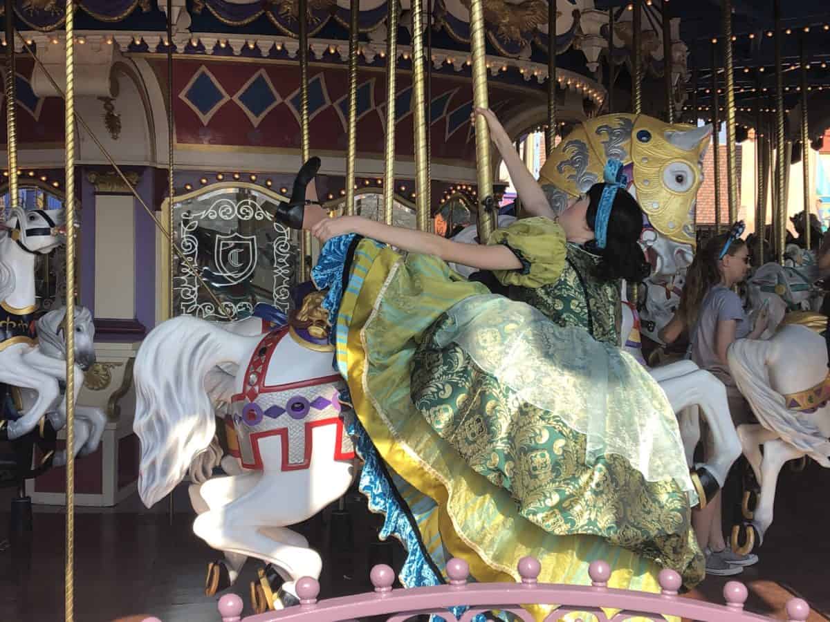Ugly Stepsister climbing off of a carousel horse