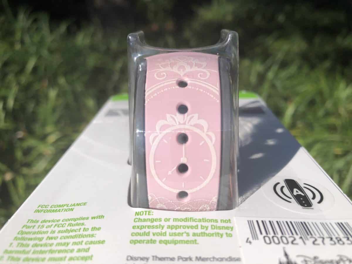 Details of a clock in white on the pink magicband