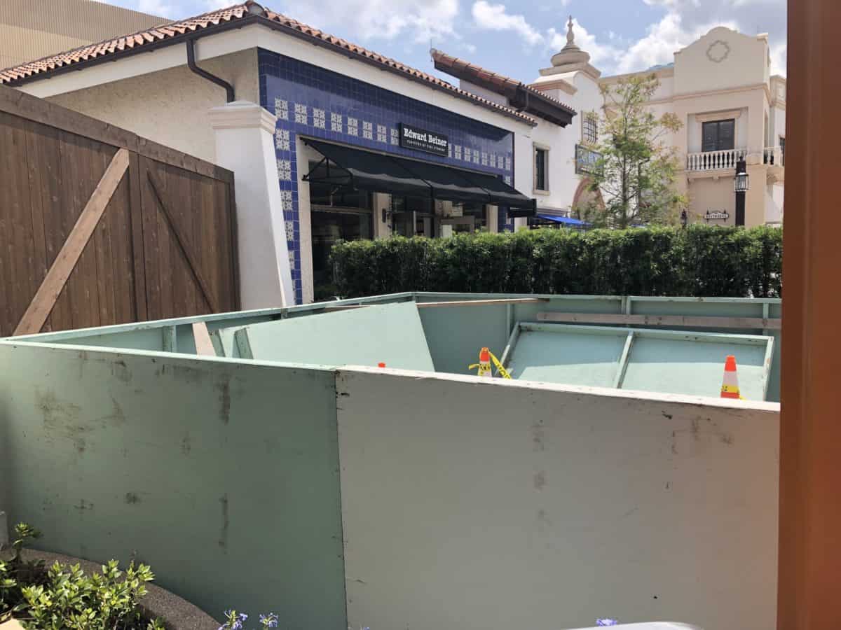 some strange boxes behind a wall of bushes.