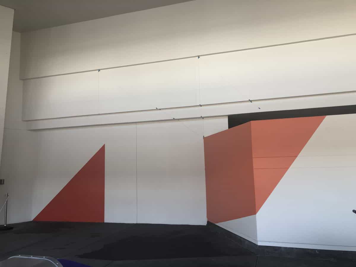 Tomorrowland getting new paint by the Stitch meet and greet. Two shades of bright orange against the white walls