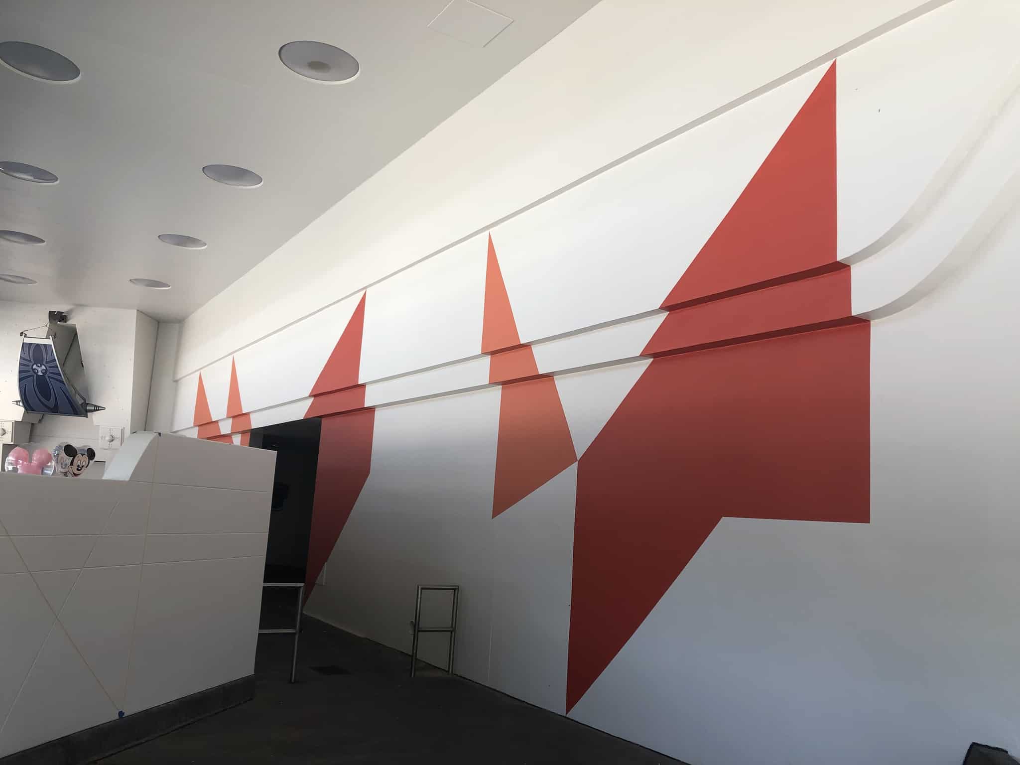 Tomorrowland walls painted two shades of orange, but marked for more paint