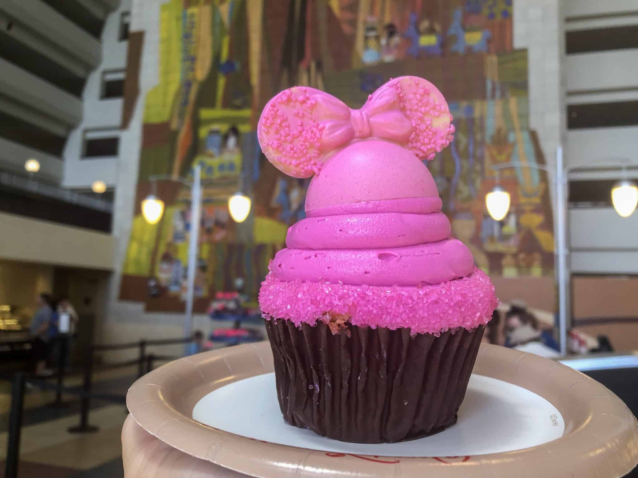 Strawberry cupcake with bright pink vanilla frosting and Imagination Pink mickey ears of white chocolate