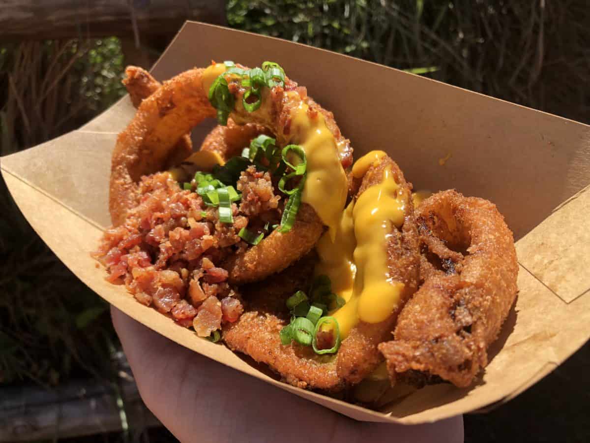 Loaded Onion Rings with cheese sauce, scallion, and bacon bits