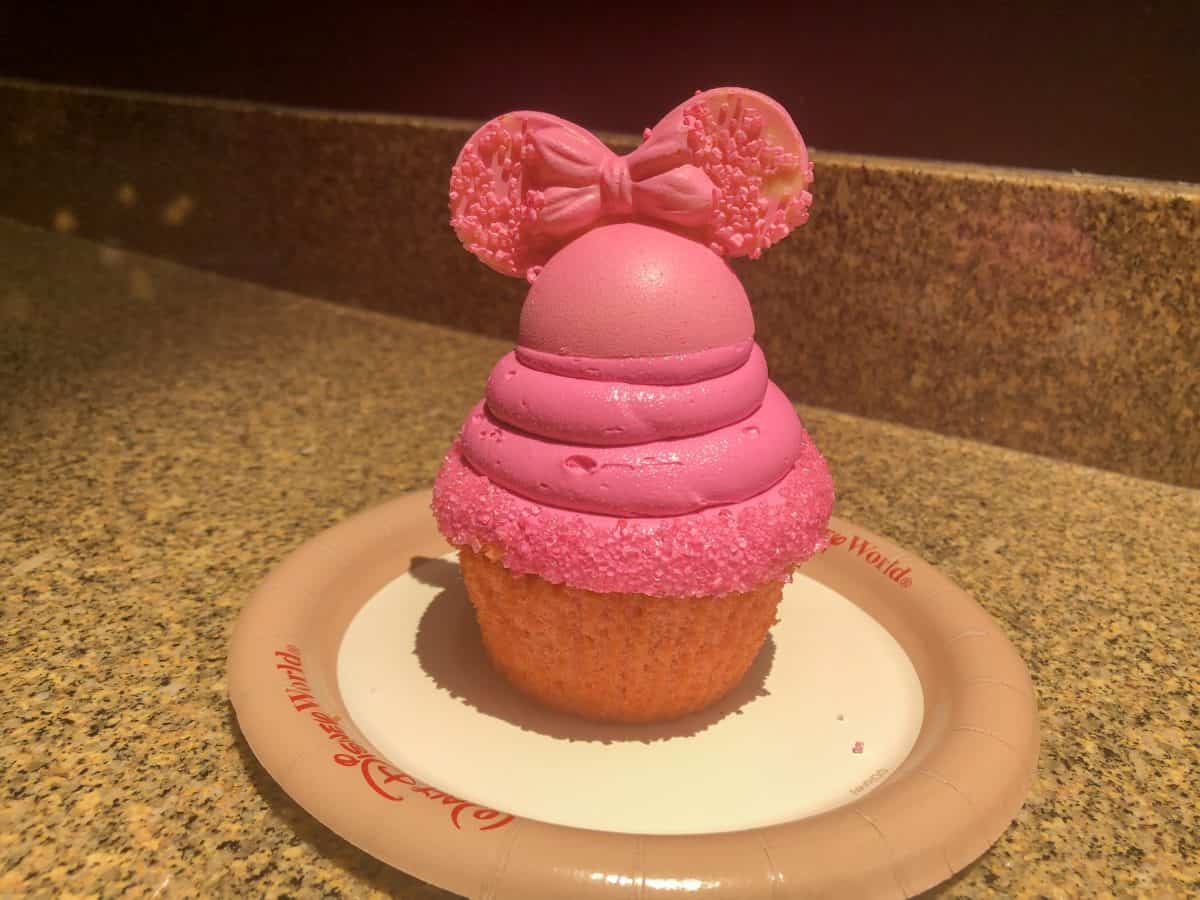 Strawberry cupcake with bright pink vanilla frosting and Imagination Pink mickey ears of white chocolate