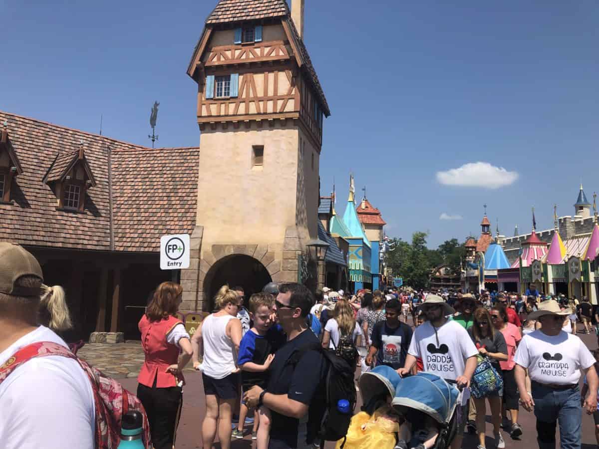 Cast member with sign at back of the line