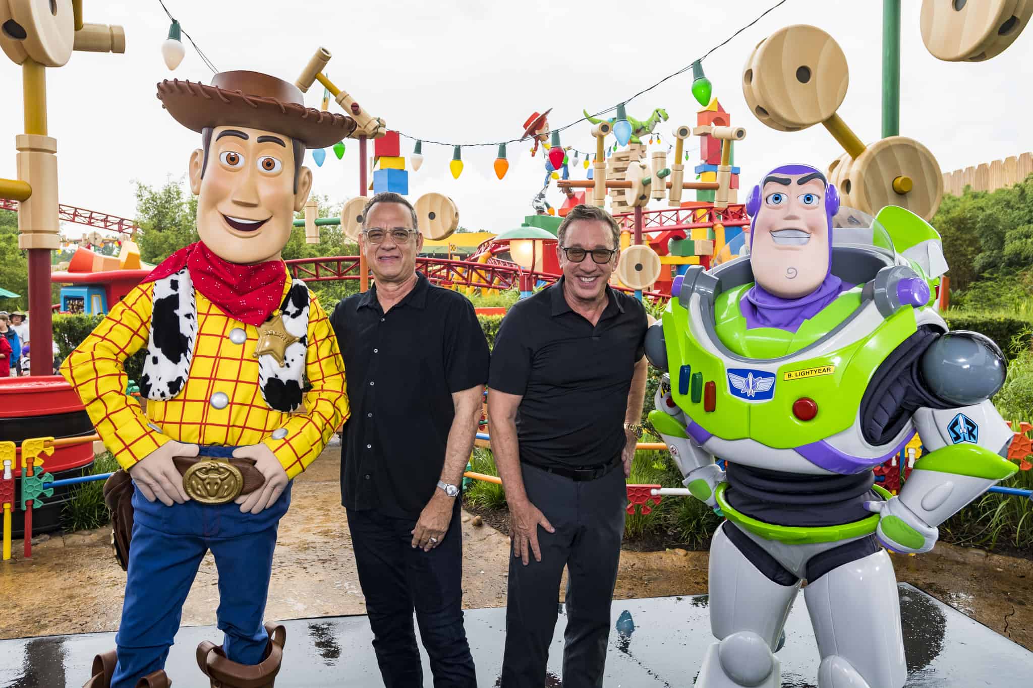 Tom Hanks and Tim Allen with Buzz and Woody in Toy Story Land