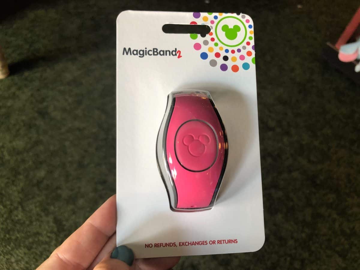 front of hot pink MagicBand in packaging