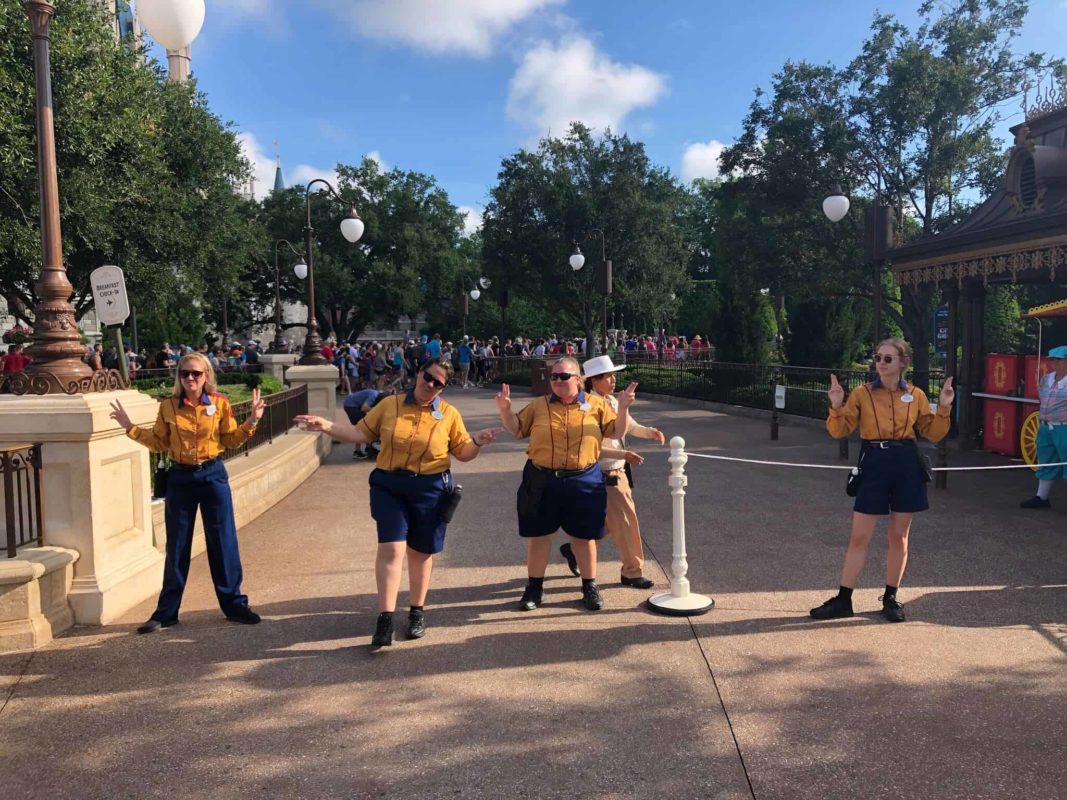 Cast Members directing morning traffic at rope drop