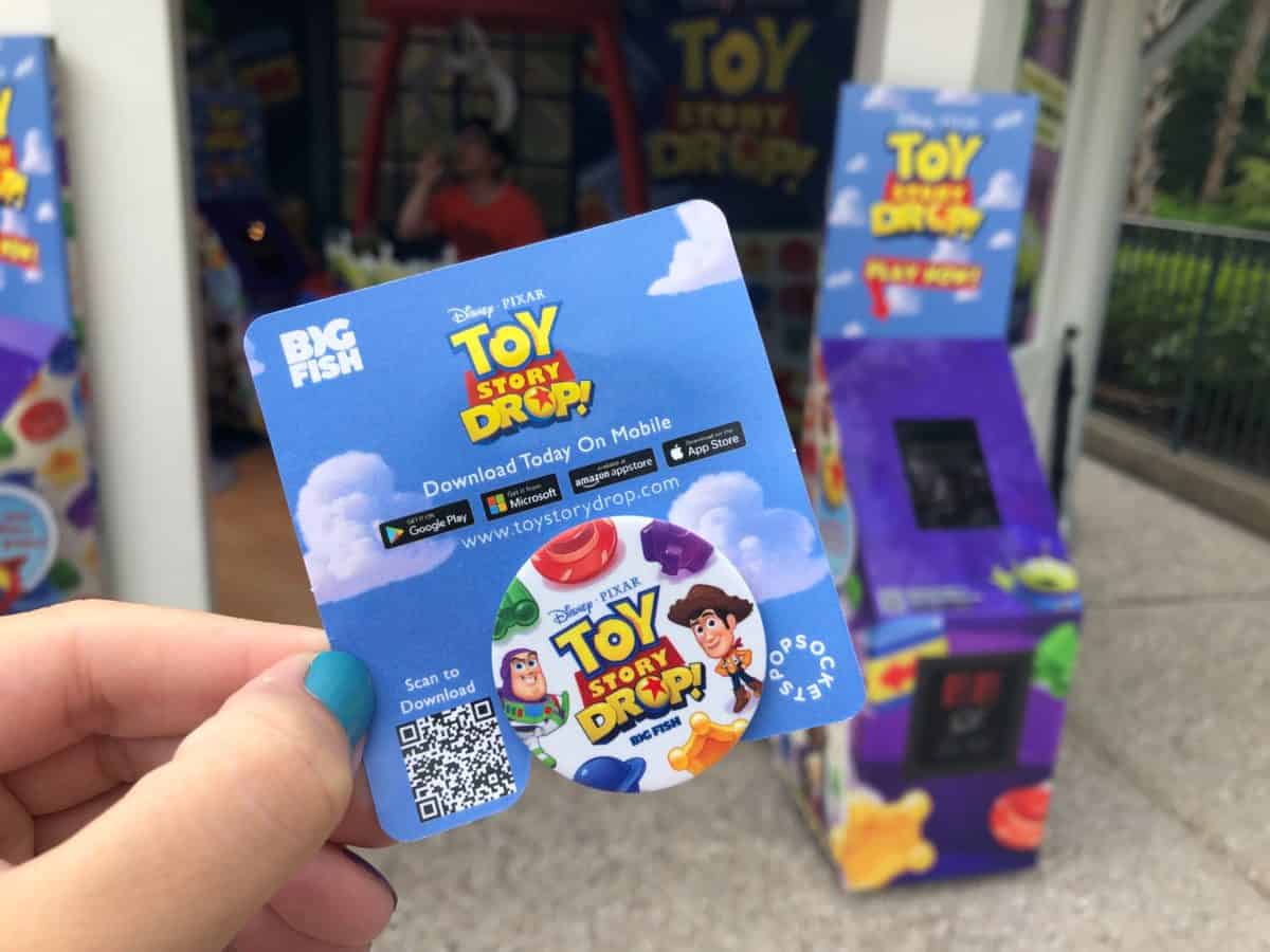 Pop Socket with Toy Story Drop logo, Buzz, and Woody.