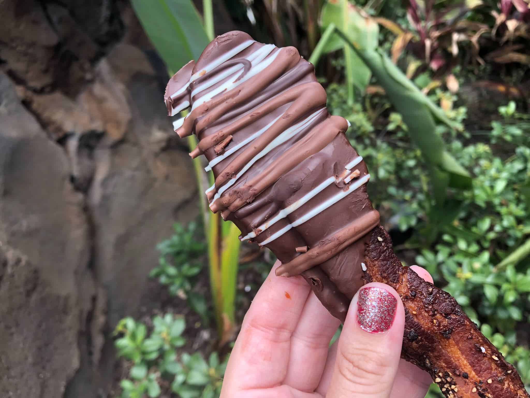 Dark chocolate dipped bacon with milk and white chocolate drizzle