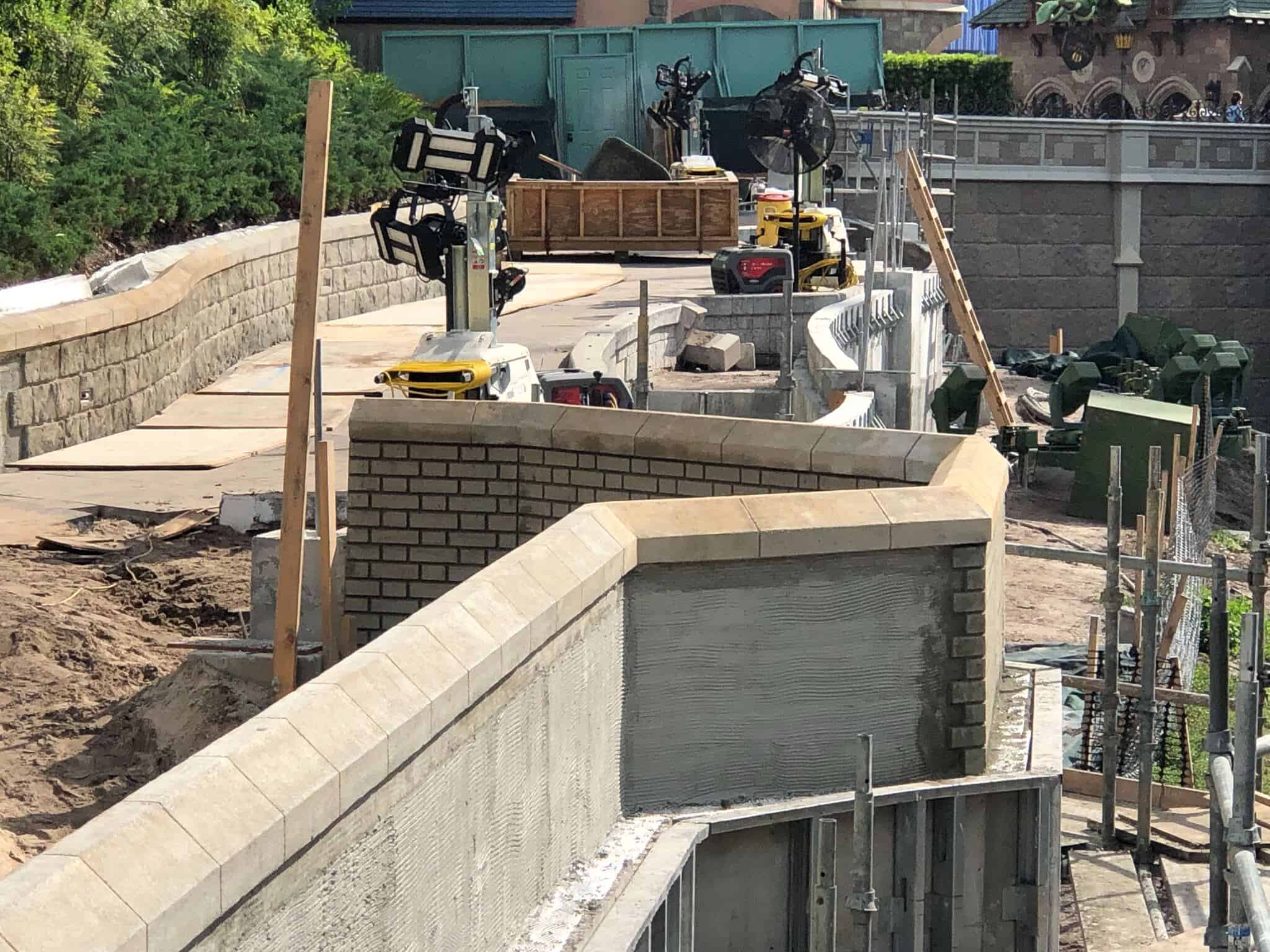 Wooden planks up the torn up pathway by Cinderella Castle