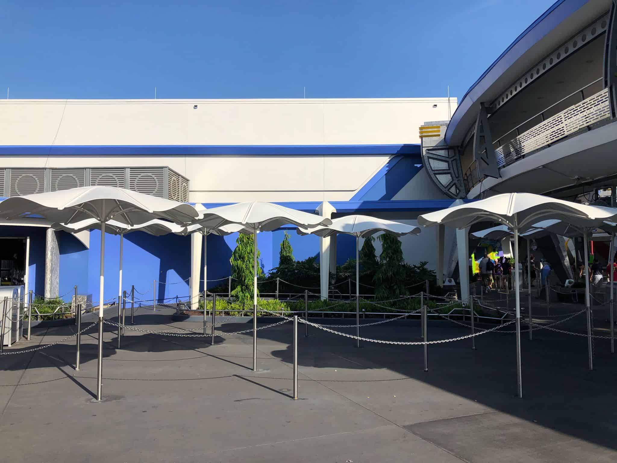 Tomorrowland Speedway Umbrellas over extended queue for Buzz Lightyear