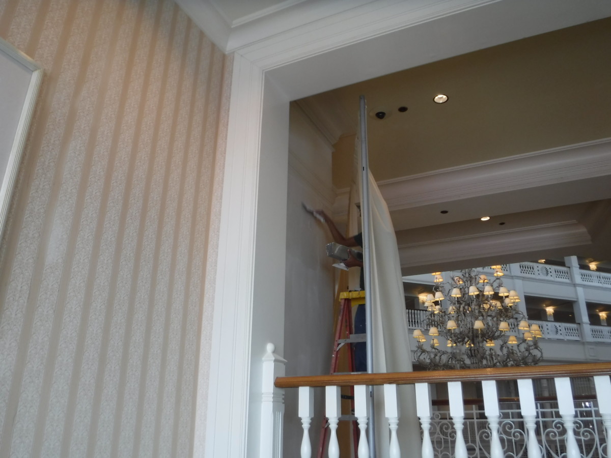 worker applying last coat of plaster to the entrance