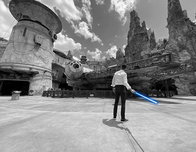 Josh D'Amaro holding a blue lightsaber in Star Wars: Galaxy's Edge