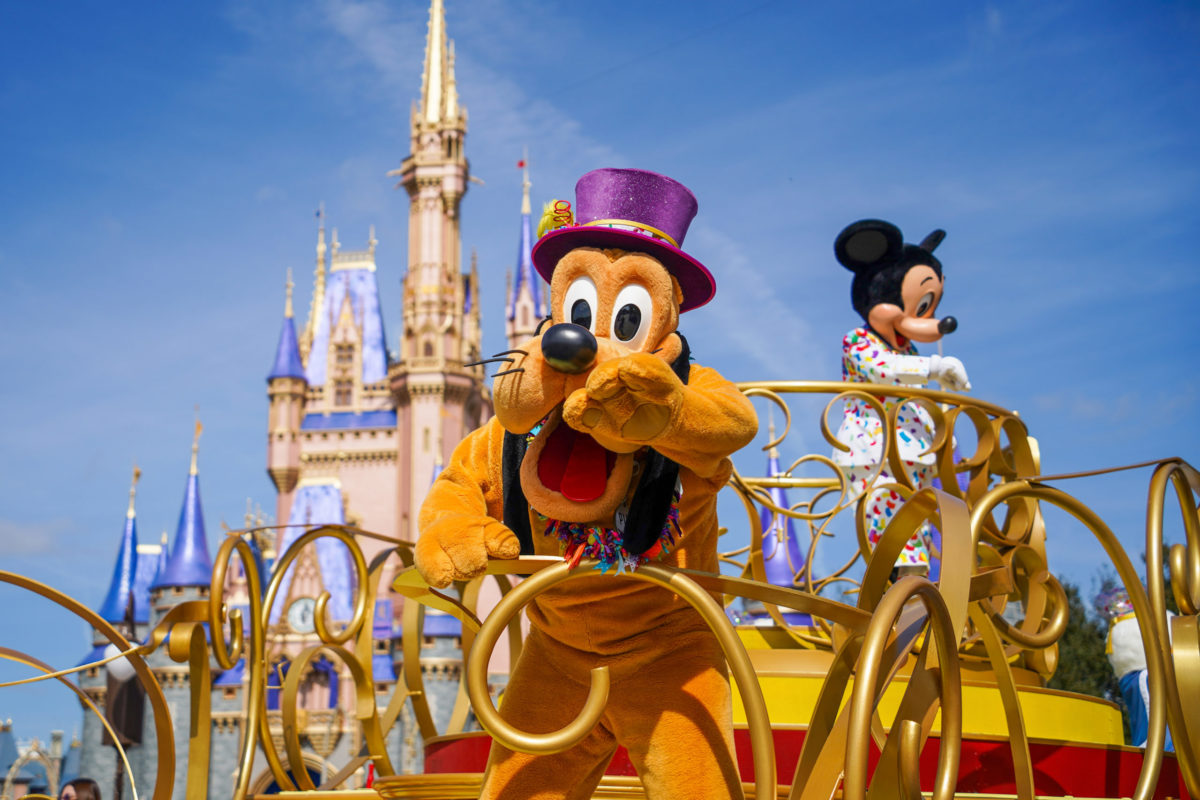 Pluto and Mickey Mouse in Character Cavalcade in front of Cinderella Castle