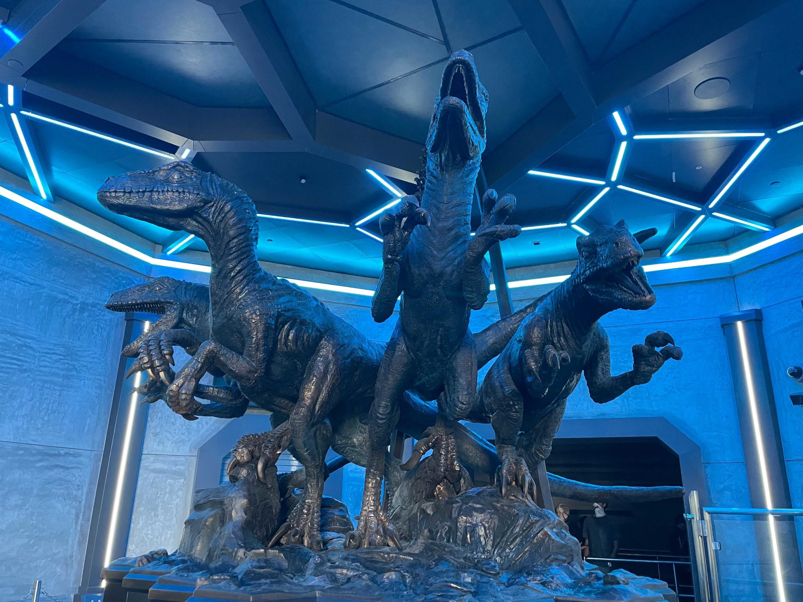 Statue of four Velociraptors inside the queue for Jurassic World VelociCoaster