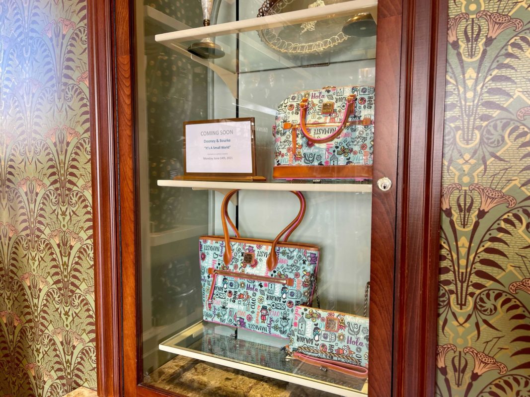 new dooney & bourke "it's a small world" collection at Uptown Jewelers in the Magic Kingdom at Walt Disney World