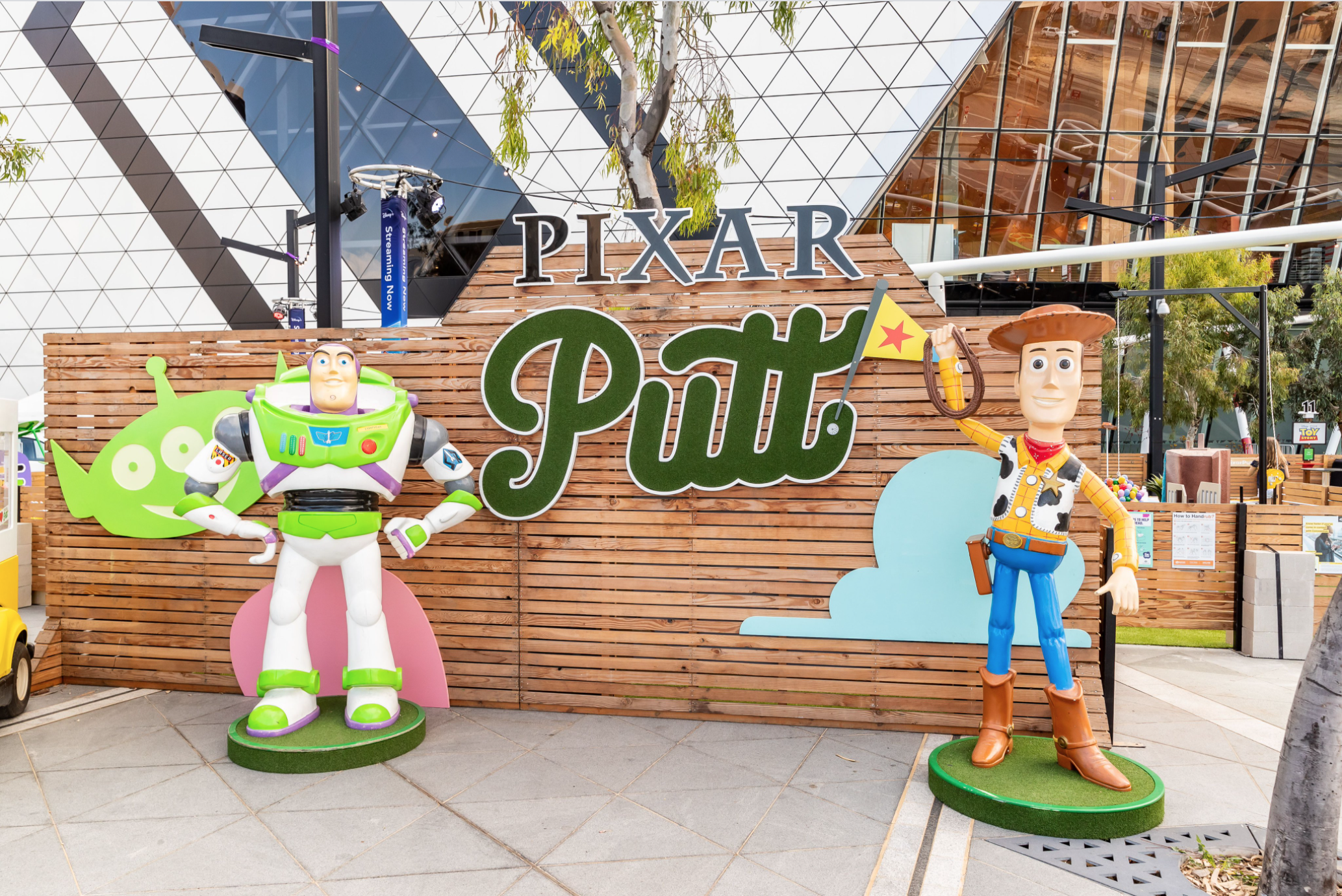 Statues of Woody and Buzz in front of a "Pixar Putt" sign