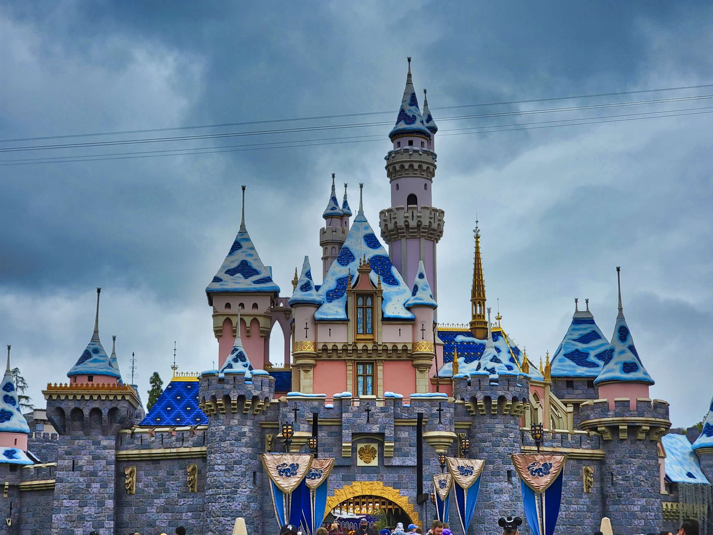 sleeping-beauty-castle-with-snow-under-cloudy-sky