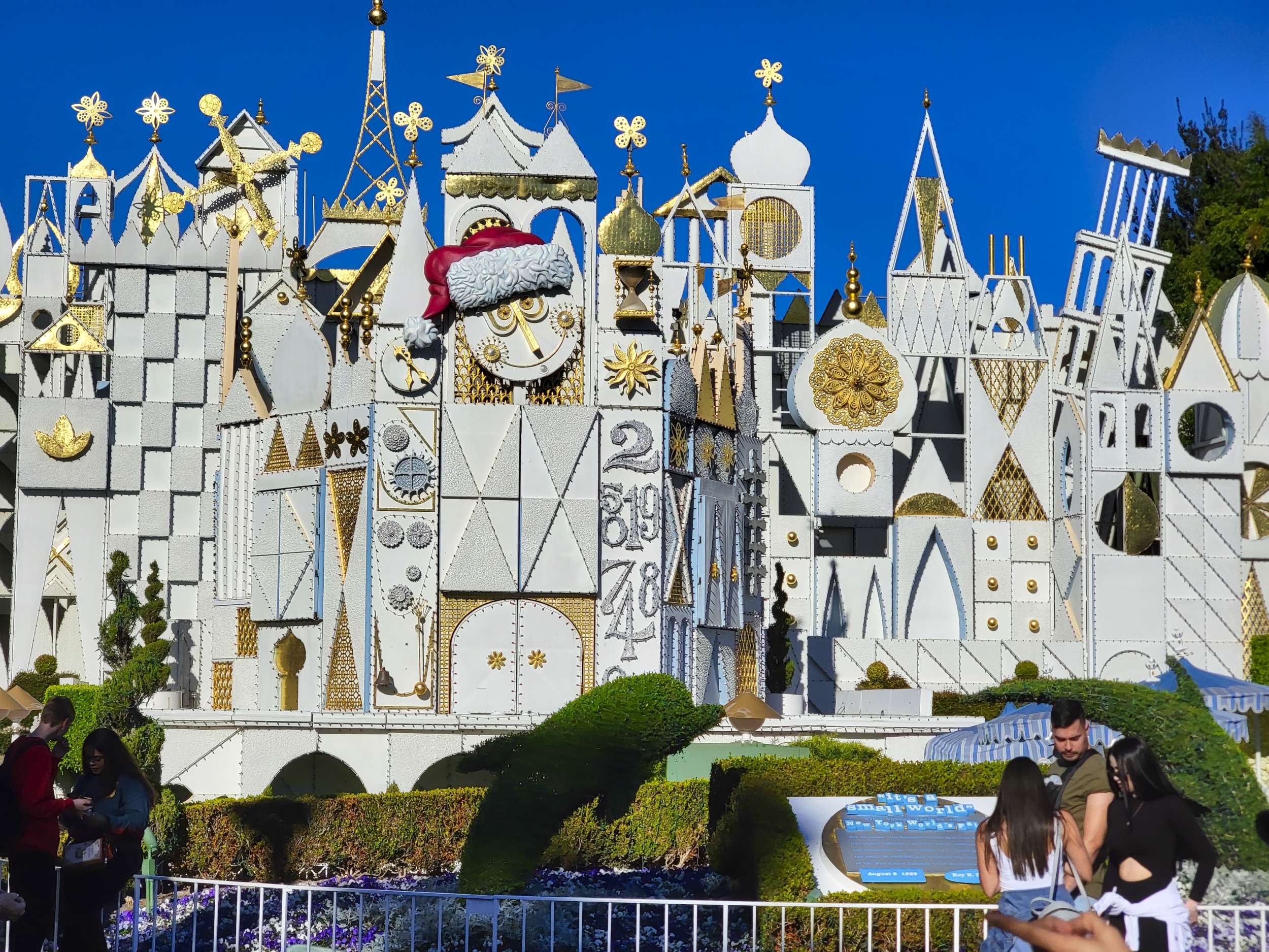 "it's a small world" Holiday exterior with Santa hat on clock