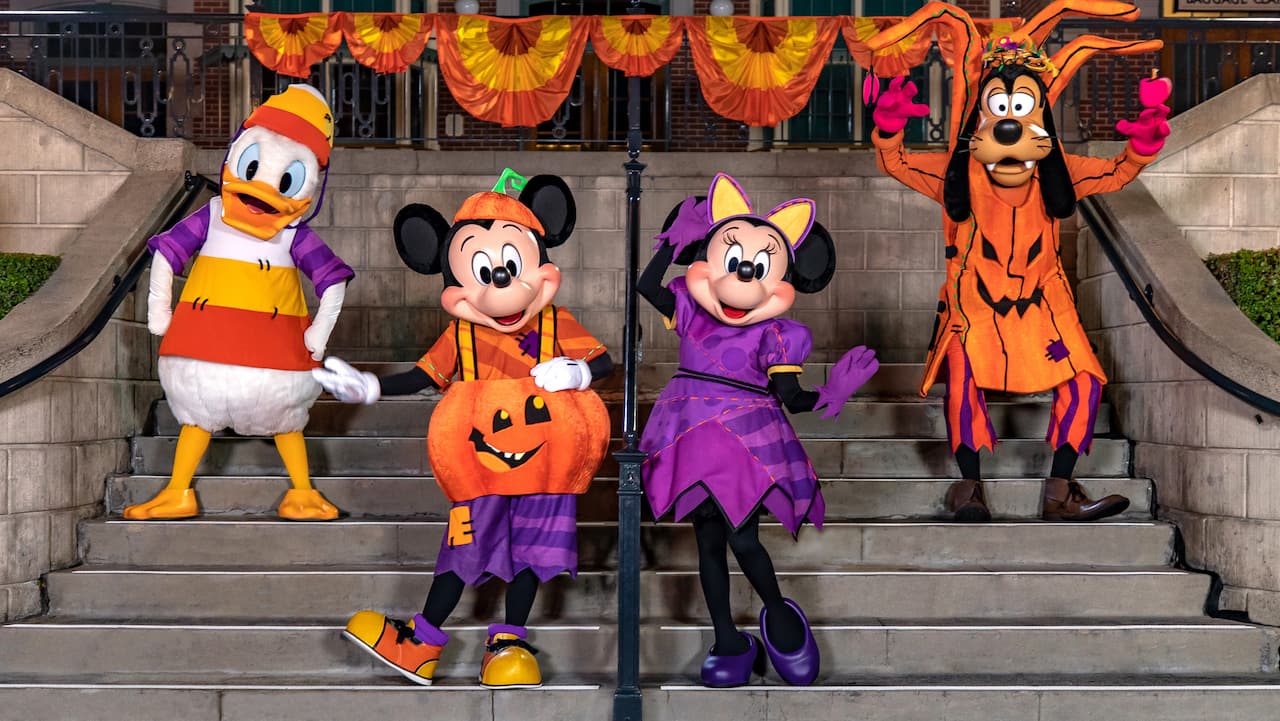 Donald, Mickey, Minnie, and Goofy in Halloween costumes