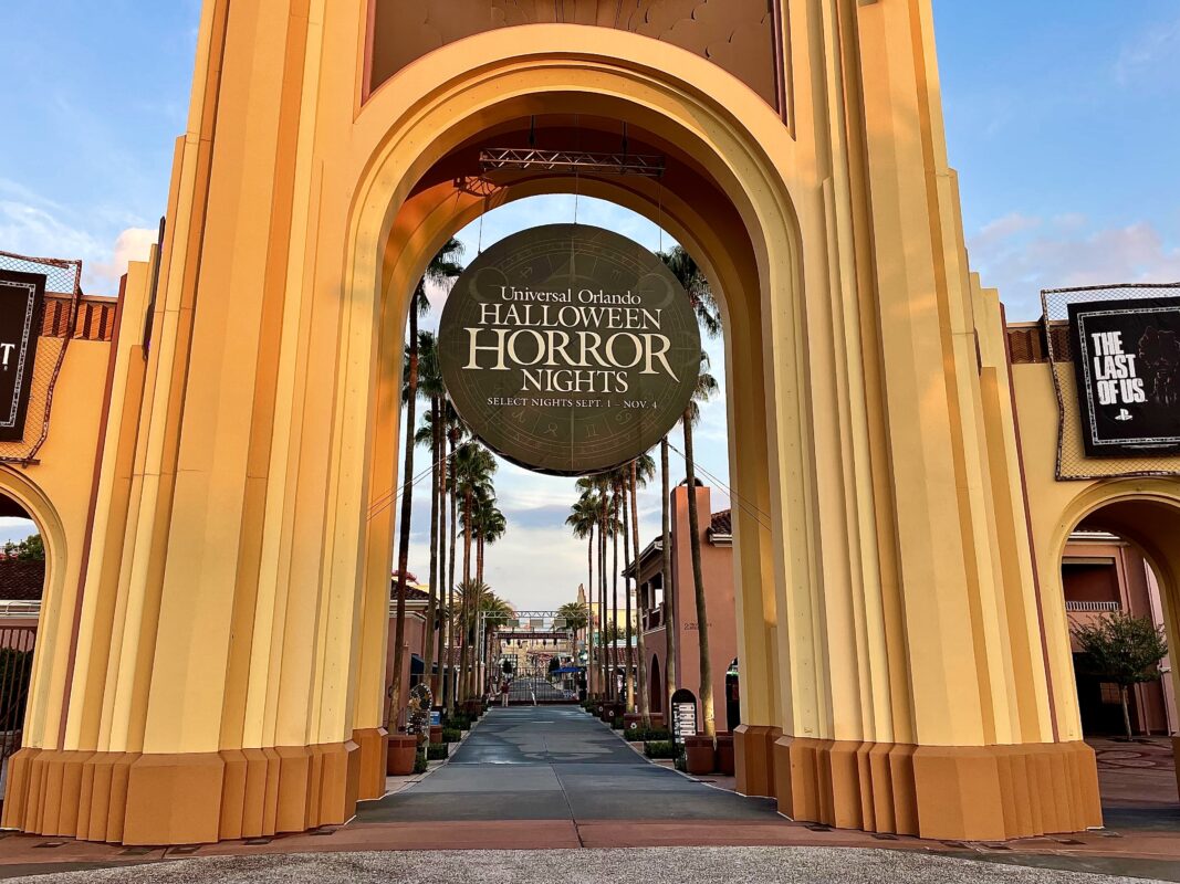 The HHN Medallion hangs from the archway entrance to Universal Studios Florida