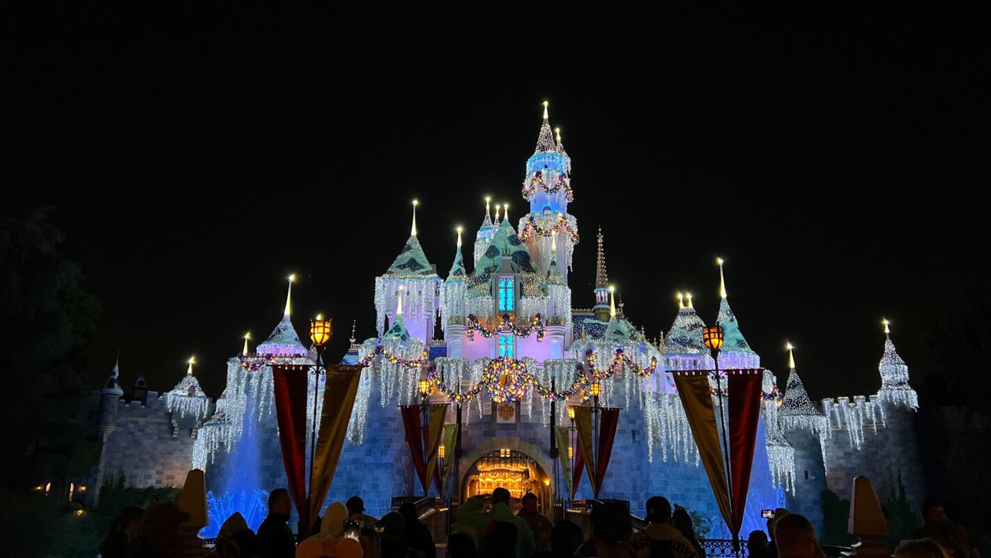 Sleeping Beauty Castle at Disneyland with holiday lights at night