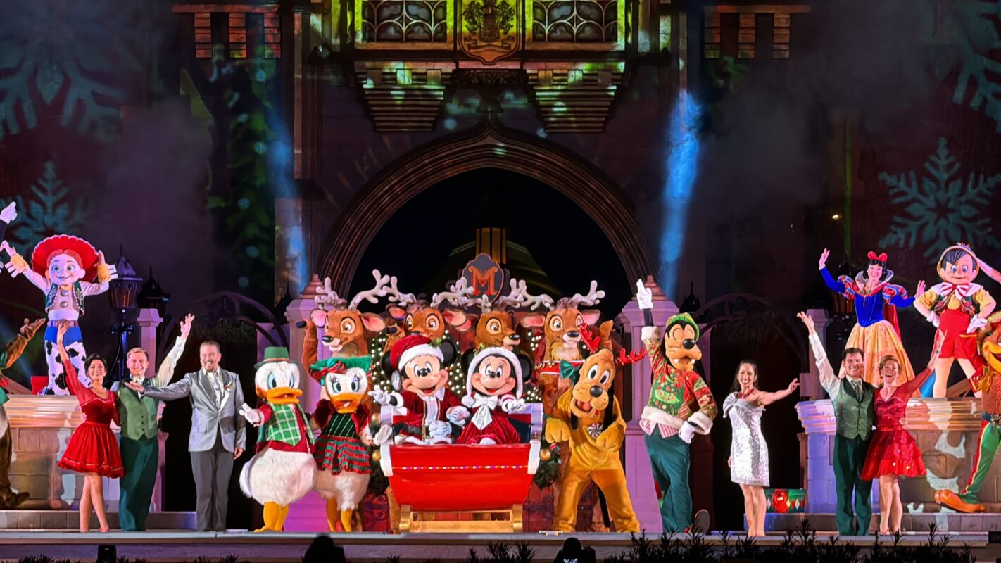 Disney characters and performers dazzle on stage during Mickey's Most Merriest Celebration at Magic Kingdom.