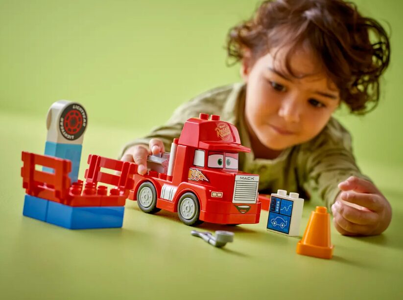 A child plays with the LEGO Duplo Mack at the Race set.