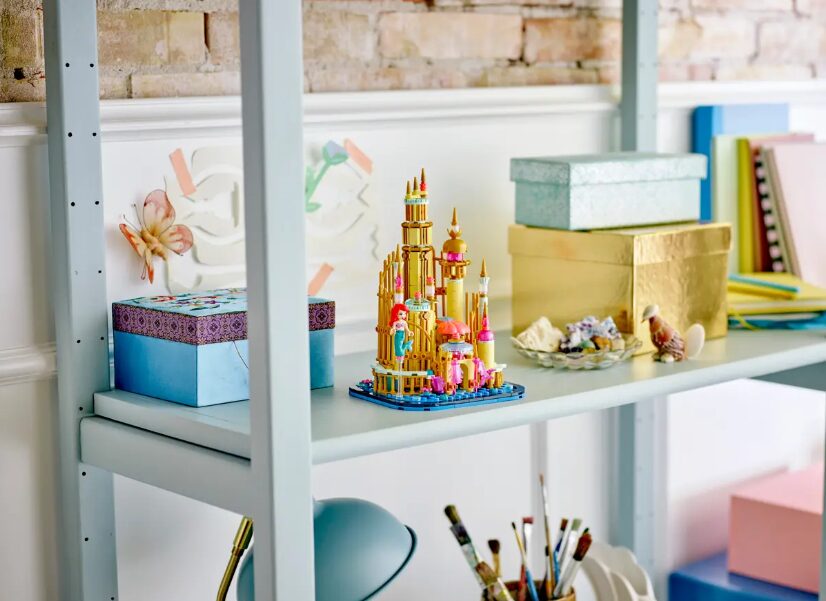 A photo of the LEGO Mini Disney Ariel's Castle set, sitting on a shelf beside storage boxes and decorative shells.