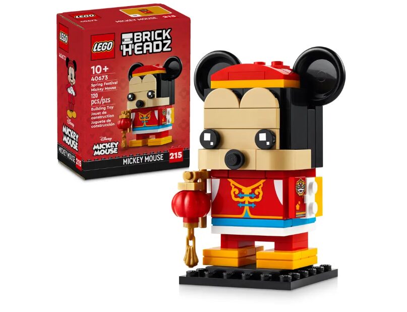 The fully build LEGO Disney Brick Headz Spring Festival Mickey Mouse figure stands with its box off in the background to the left.