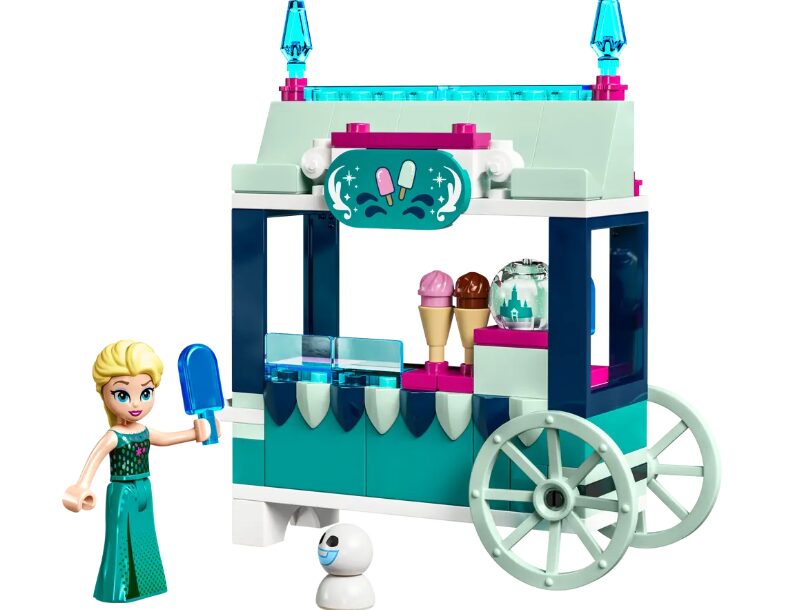 A close-up look at the LEGO Elsa's Frozen Treats set, which includes an ice cream cart, a snowgie figure, and a LEGO Disney mini doll of Elsa. She is holding a blue ice pop.