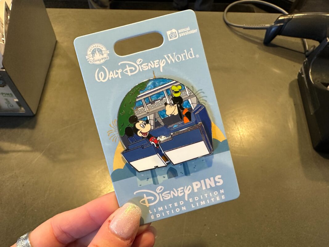 An enamel PeopleMover pin with Mickey and Goofy in a ride vehicle.