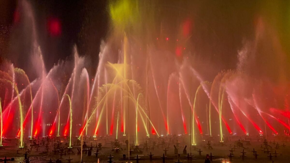 Water fountains glow red and gold during "World of Color - ONE."