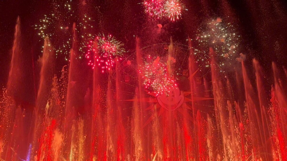 Red and gold fireworks explode in the sky.