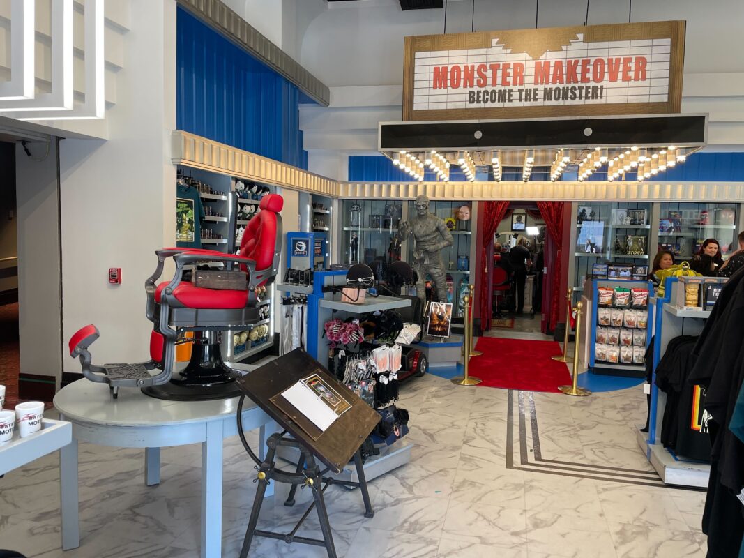 A wide shot showing the location of the Monster Makeover entrance inside the shop.