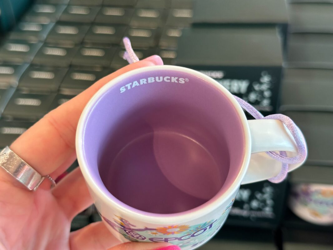 A reporter shows the inside of the EPCOT espresso mug ornament.