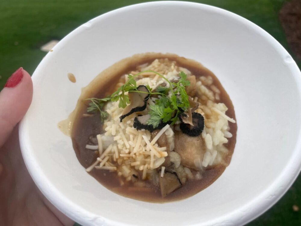 A small white bowl with a small serving of risotto.