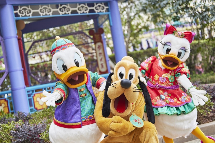 Donald, Pluto, and Daisy wearing their Chinese New Year outfits.