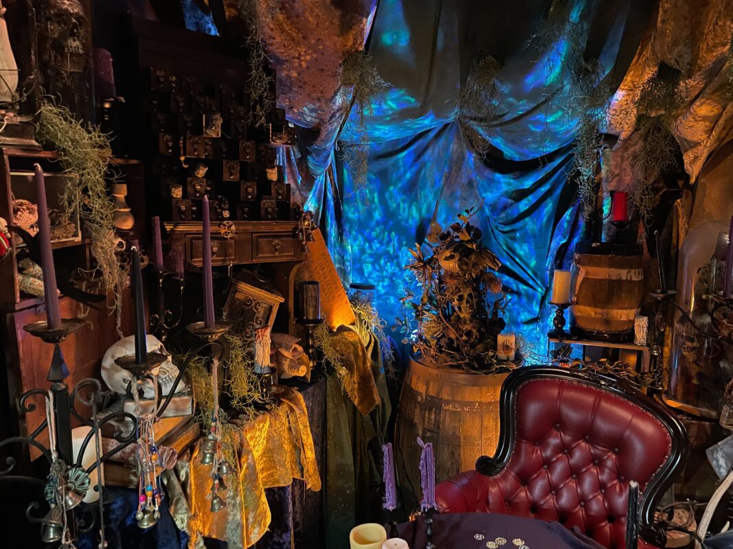 A closeup to theming behind the chair and table in the All Hallows Bayou Boutique
