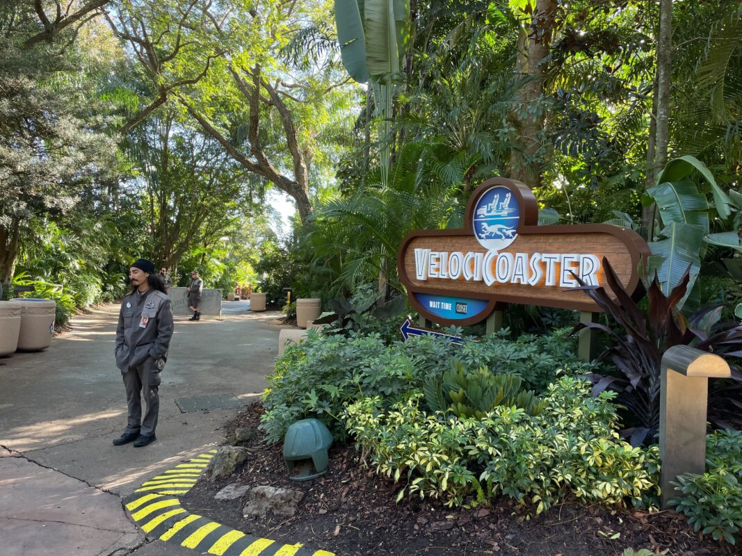 Jurassic World VelociCoaster sign with Team Member