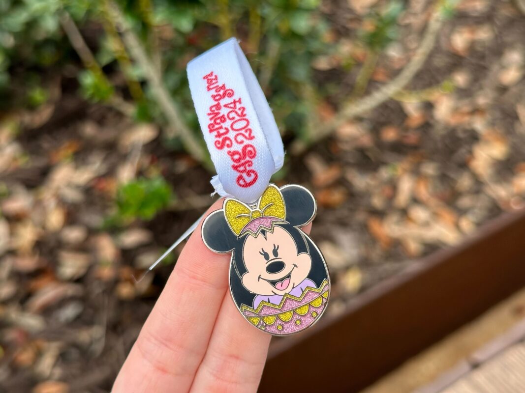 A reporter's hand holds the Minnie Mouse prize charm for Eggstravaganza 2024.